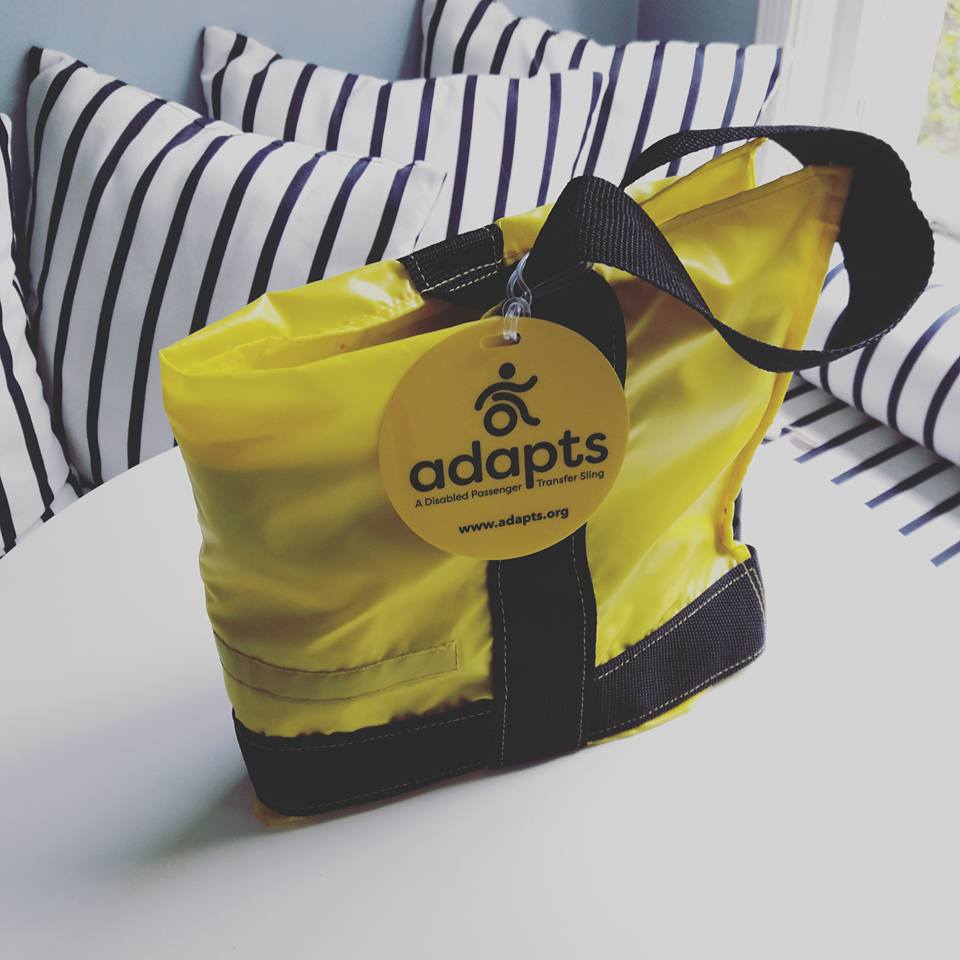 ADAPTS folded into a portable yellow tote sitting on a table.