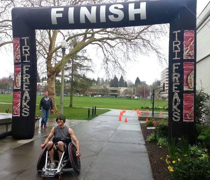 Jayden passing through the finish line in his racing wheelchair at the Tri Freaks race.