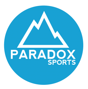 A blue circle with the outline of a mountain in white with "Paradox Sports" written in white.