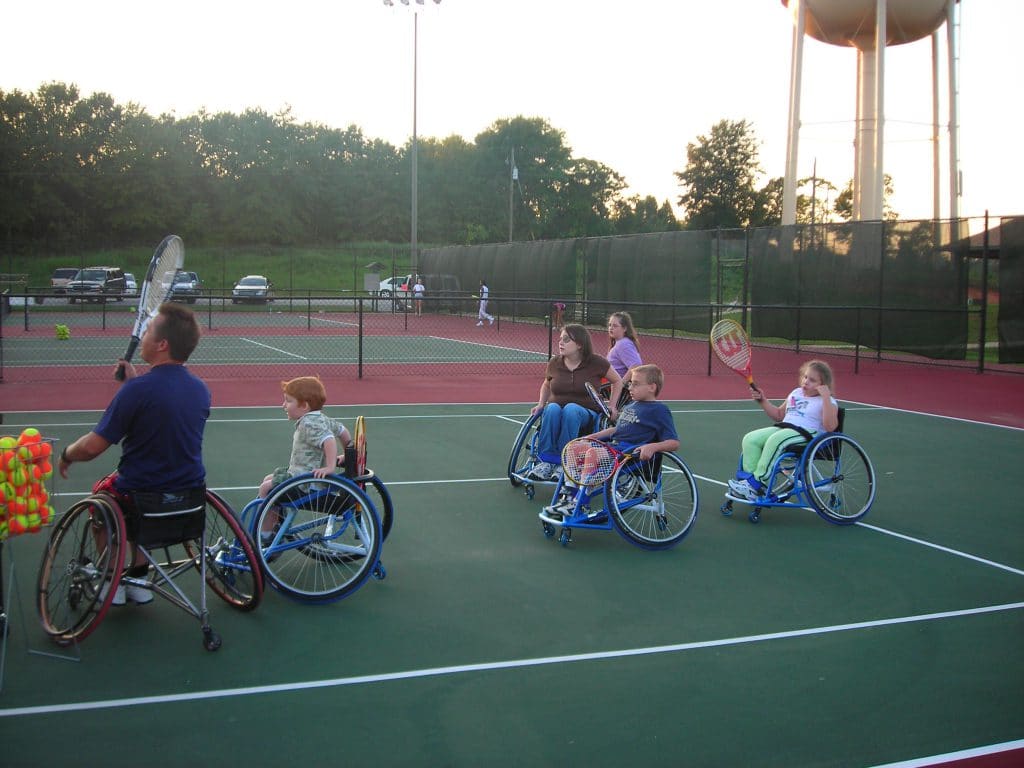 Wheelchair Tennis instructor Harlon Matthews teaches kids the joy of tennis.