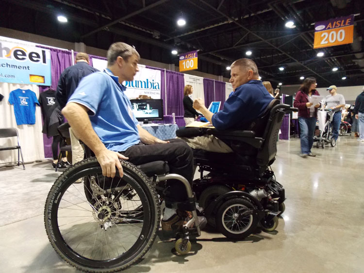 Pat Dougherty explains FreeWheel to a new fan at a recent Abilities Expo.