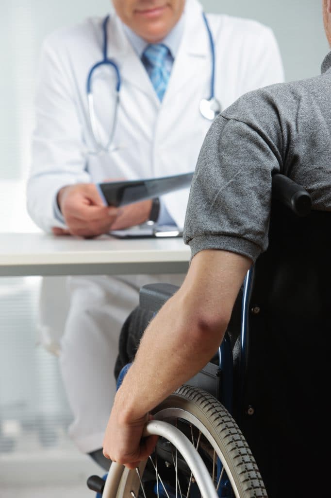 Disabled young man at doctor office