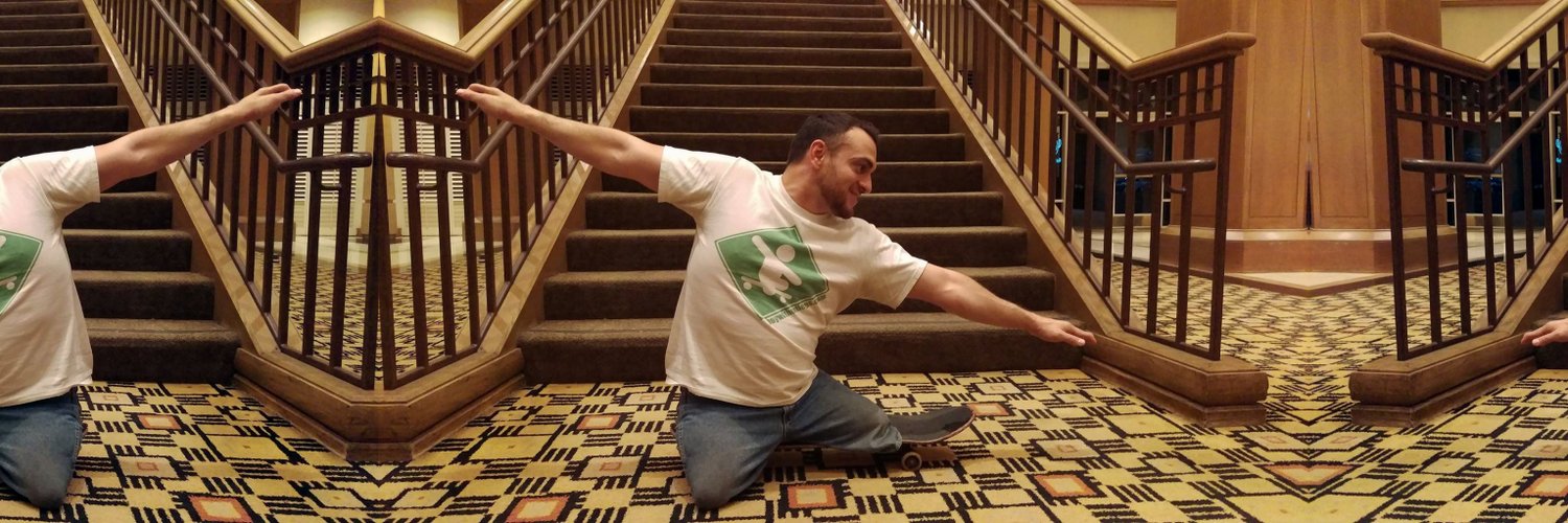 Paco on his skateboard in front of staircase.