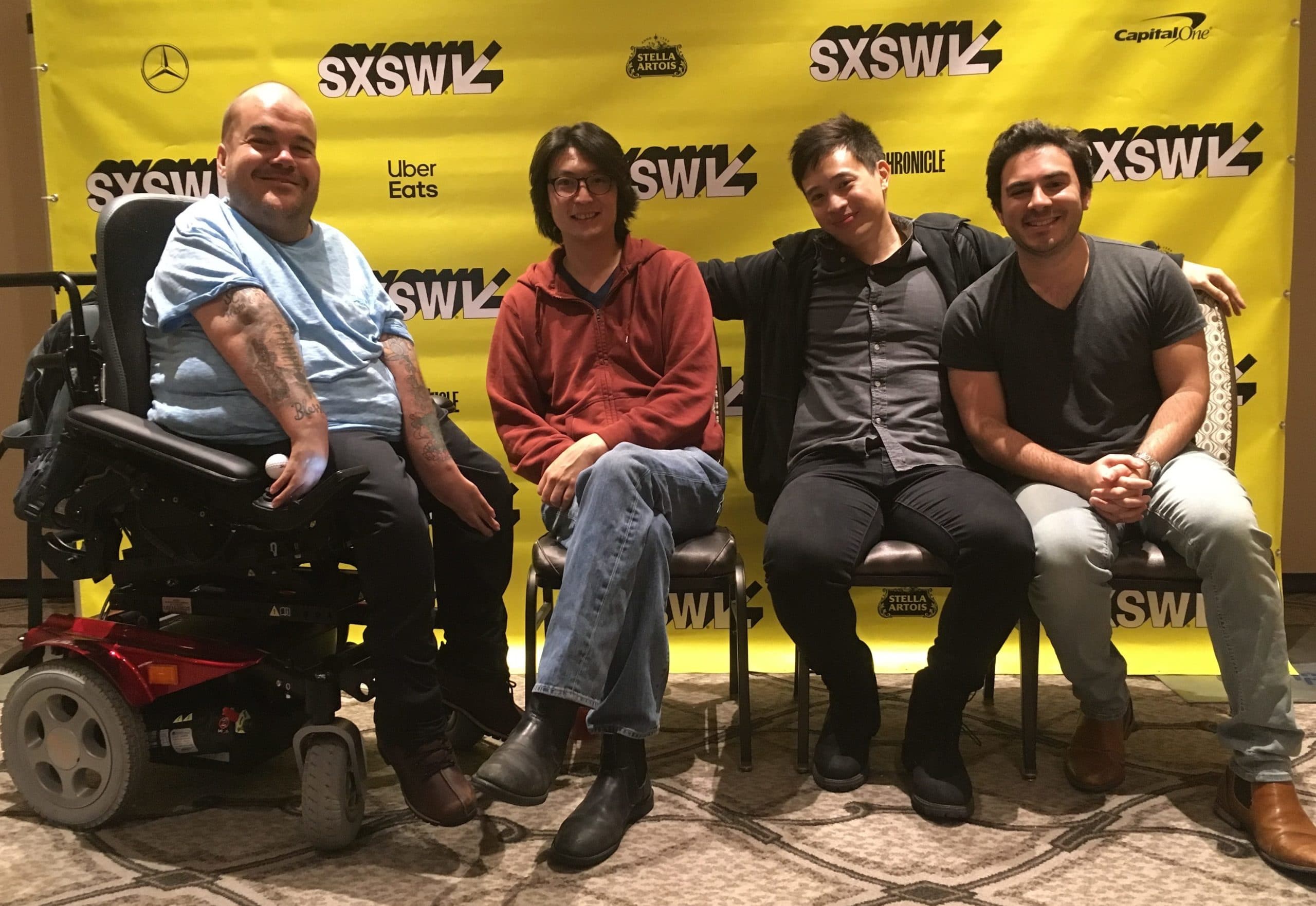 Asta Philpot, Richard Wong, Hayden Szeto, and Grant Rosenmeyer seated in front of yellow SXSW banner
