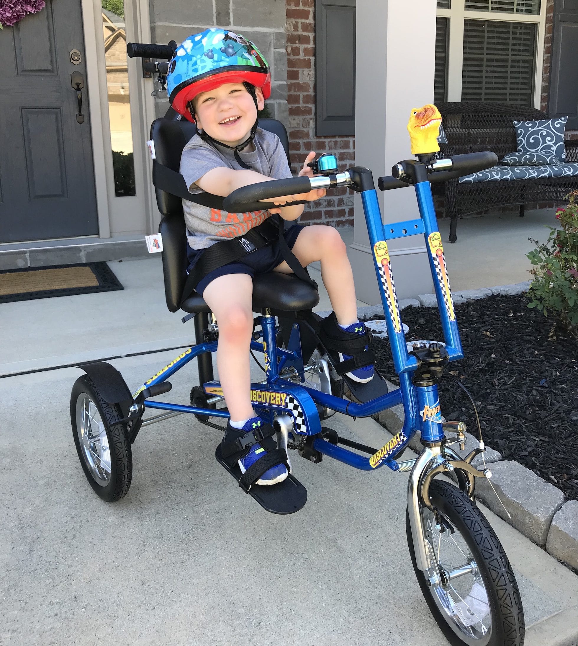 A young boy on his blue Freedom Concepts bike.
