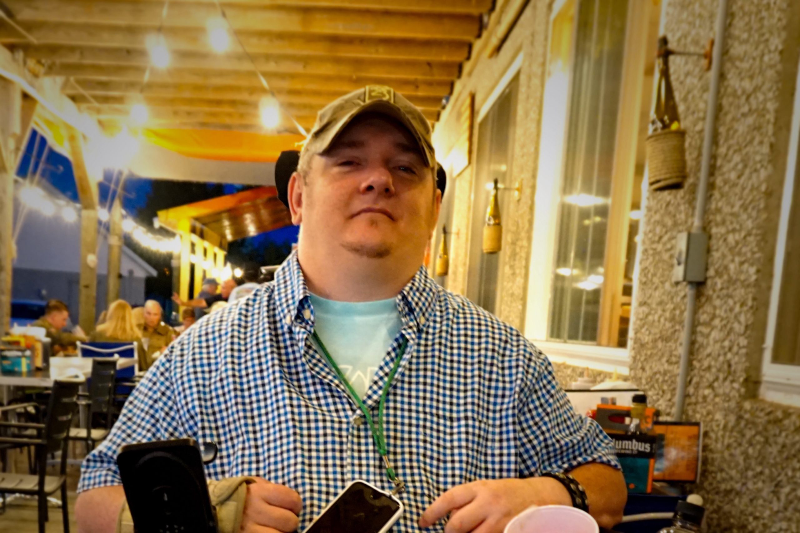 Tim Taylor sits at an outdoor restaurant table.