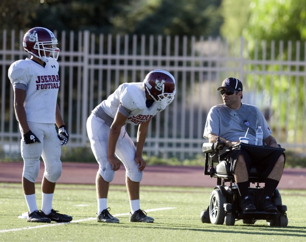 Minna coaches two football players.