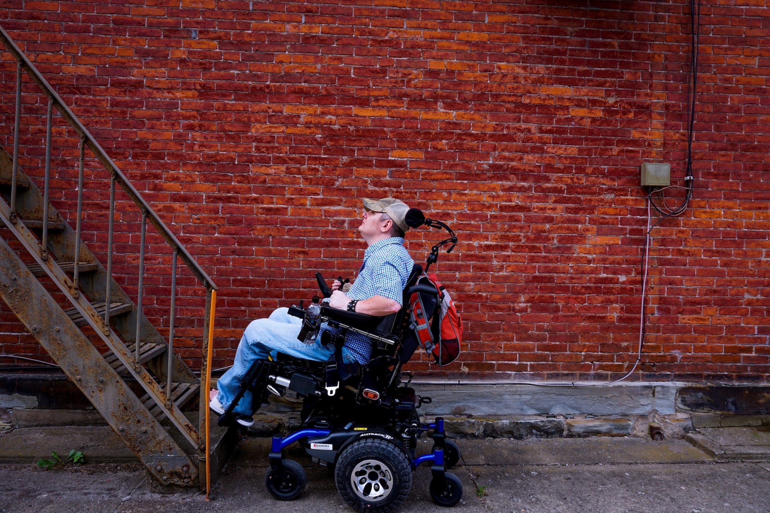 Tim Taylor faces a set of stairs in his power wheelchair.