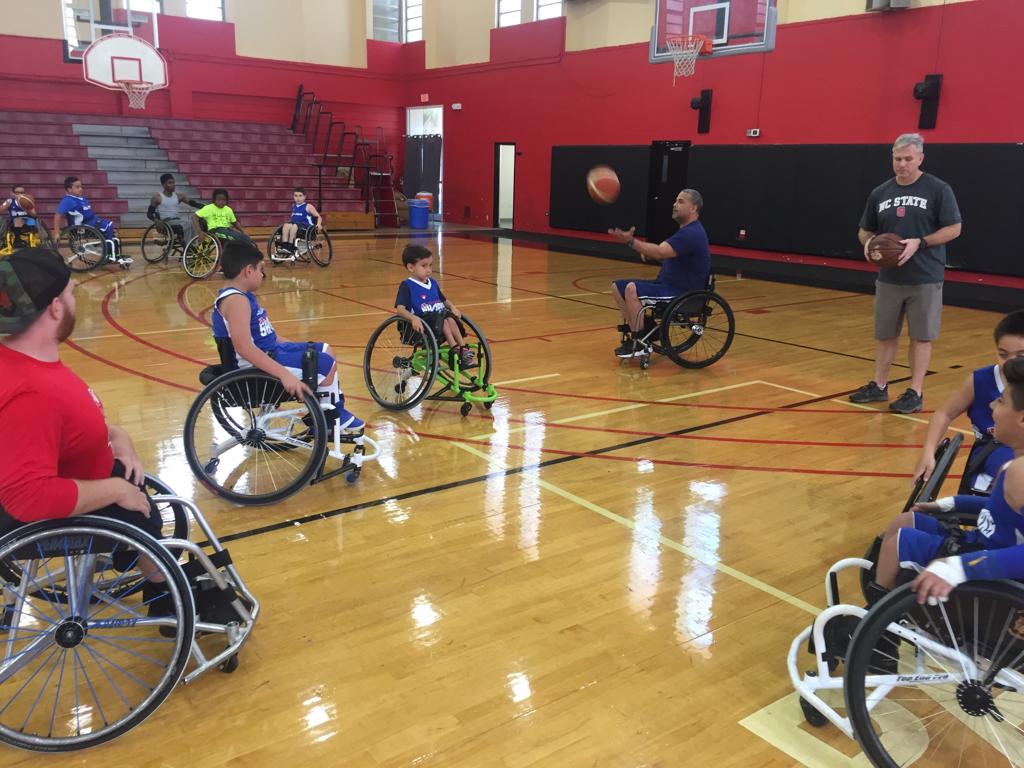 Luis on the basketball court coaching his players.