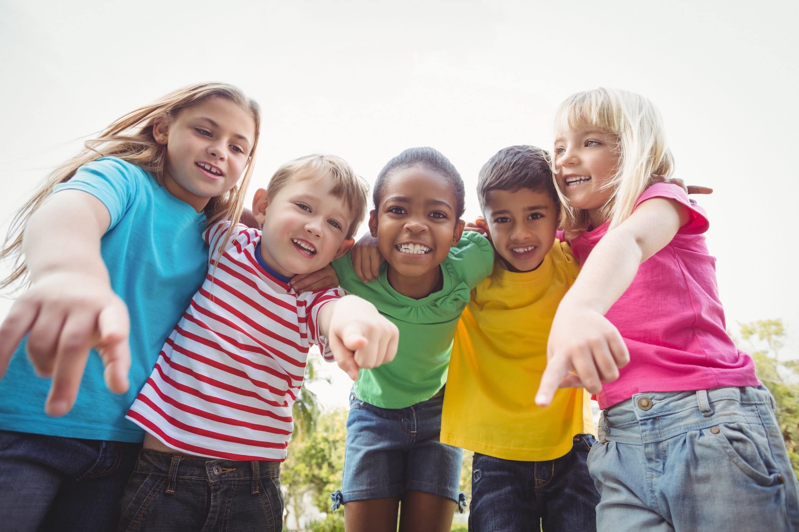 A group of kids pointing toward the camera