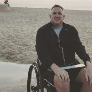 Stefan Freeman sitting in his wheelchair at the beach.