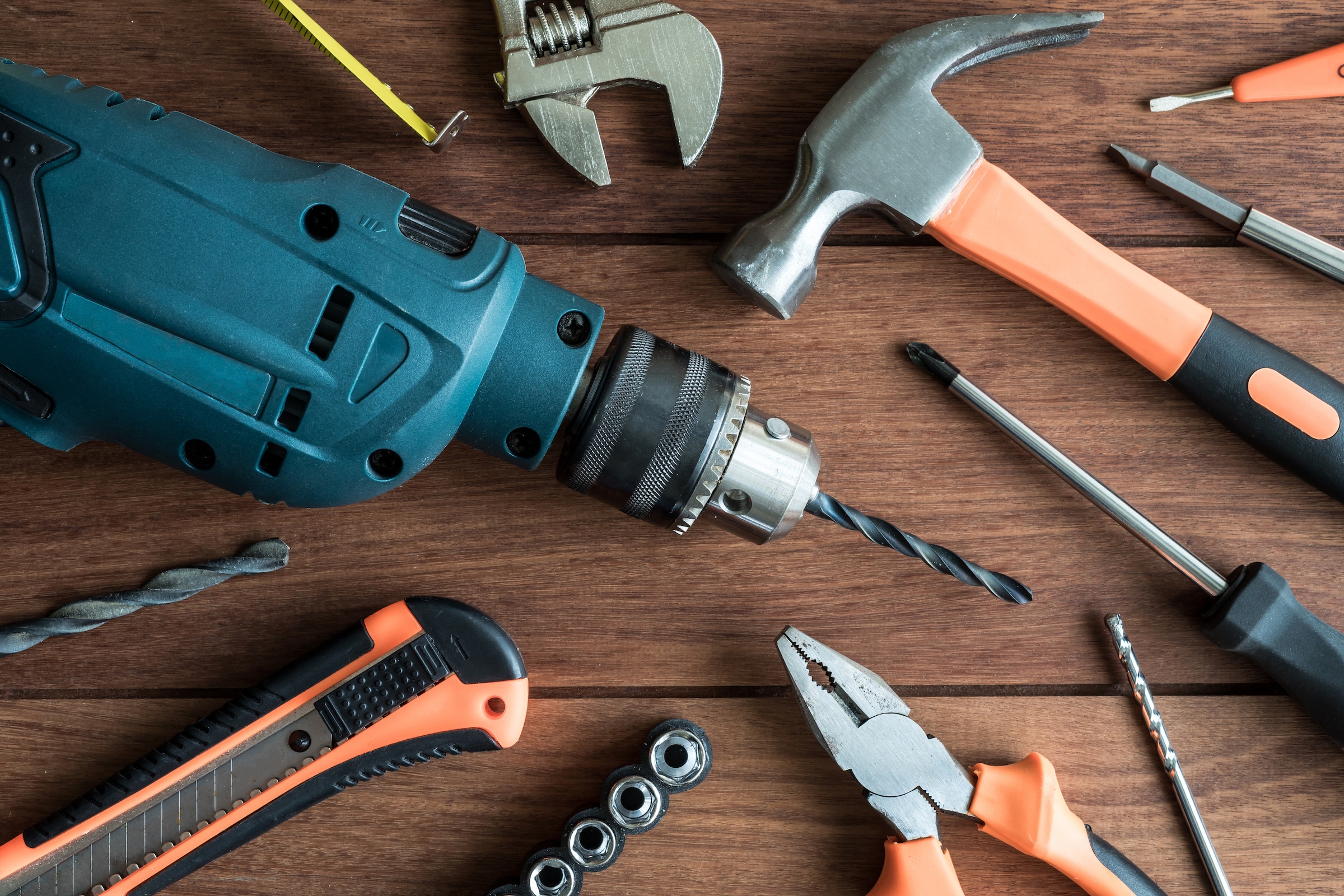 Top view of a set of work tools on wooden background