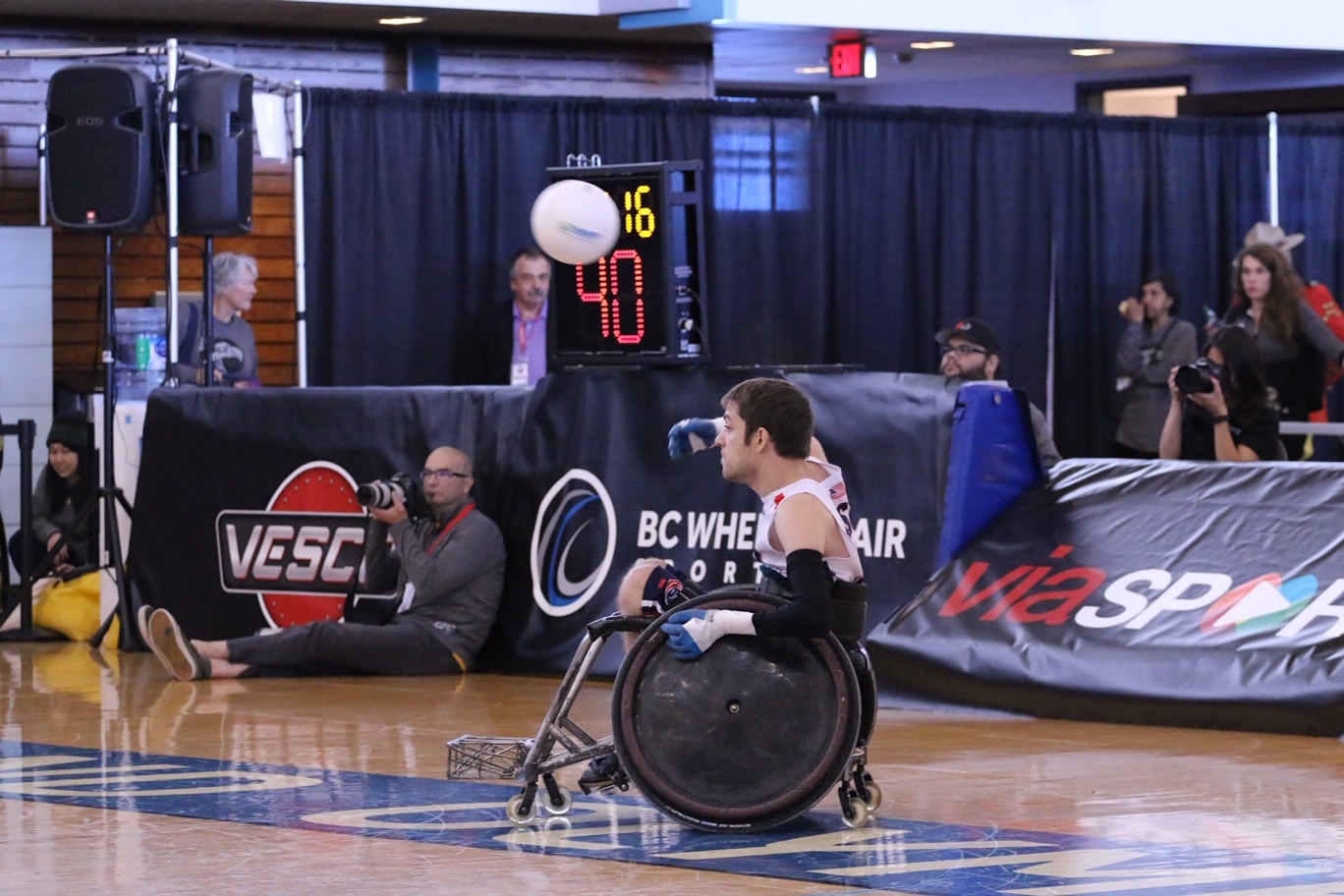 Jeff Butler throws the ball from his wheelchair while playing wheelchair rugby.