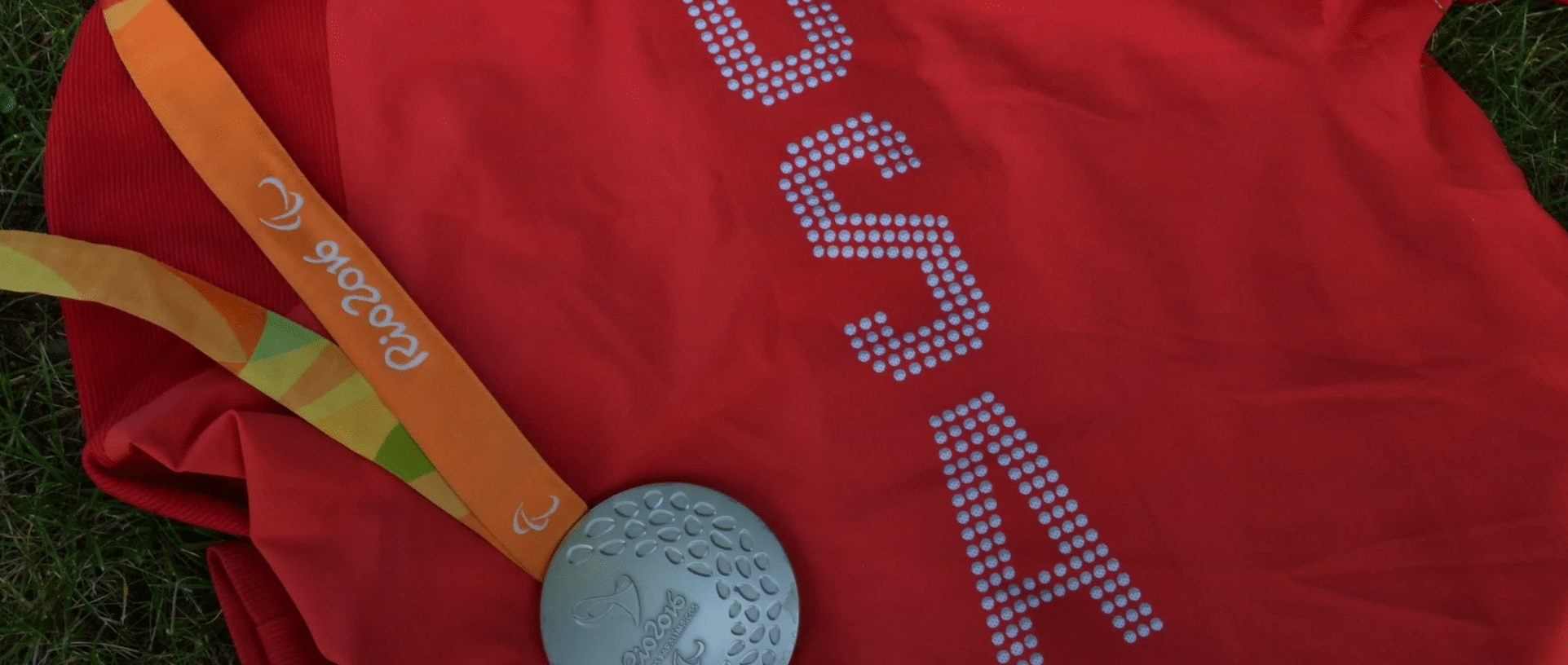 A red Team USA Wheelchair Rugby jersey with a silver medal from the 2016 Paralympic Games.