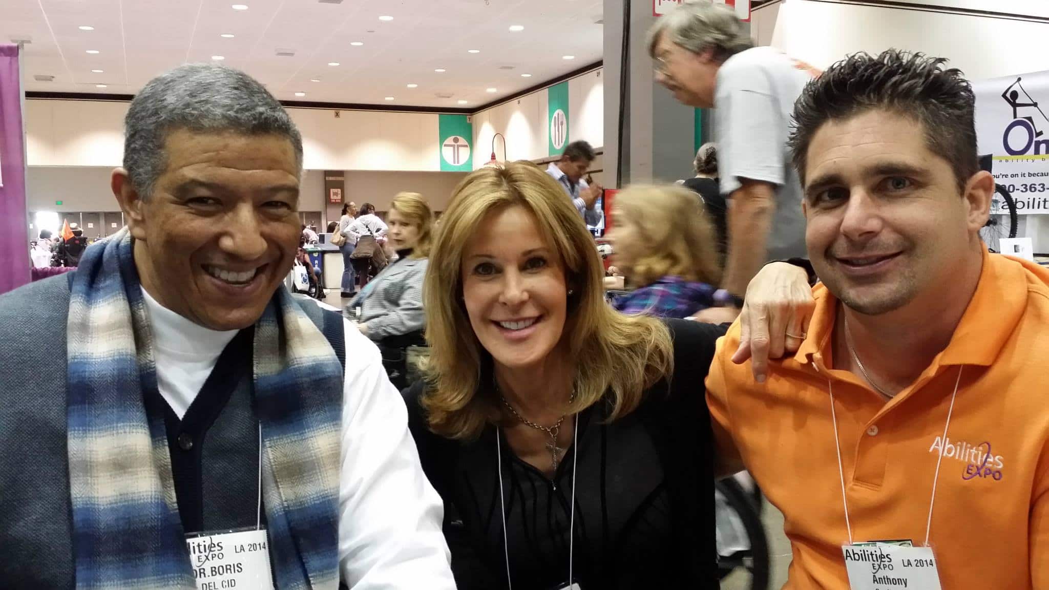 A man with Dr. Boris on a name tag next to Mayra Fornos and Anthony Orefice at Abilities Expo.