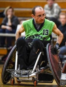 Jayden in his rugby wheelchair wearing a bright green jersey.